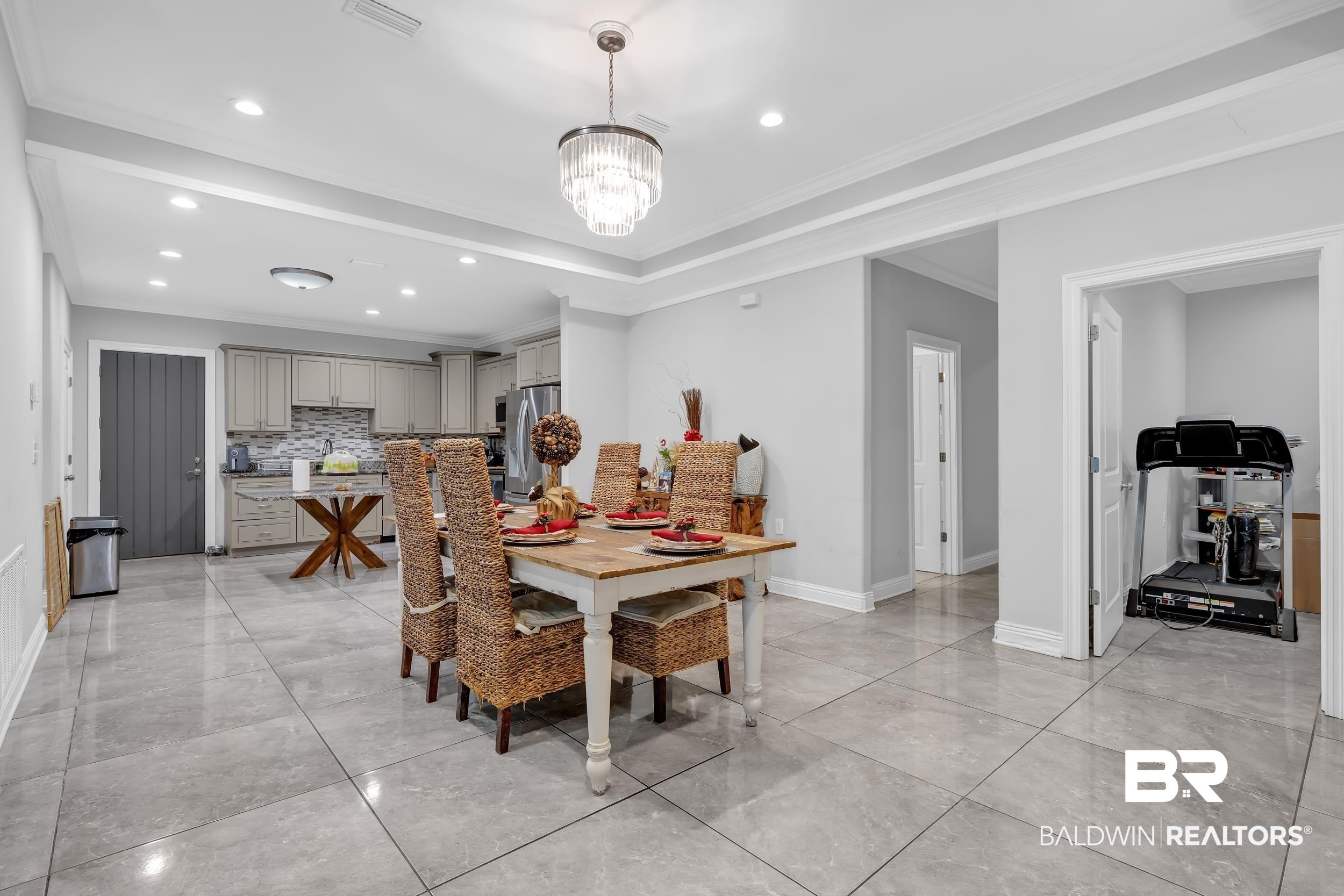 Image 4: Dining room featuring crown molding, recessed lighting, and a chandelier