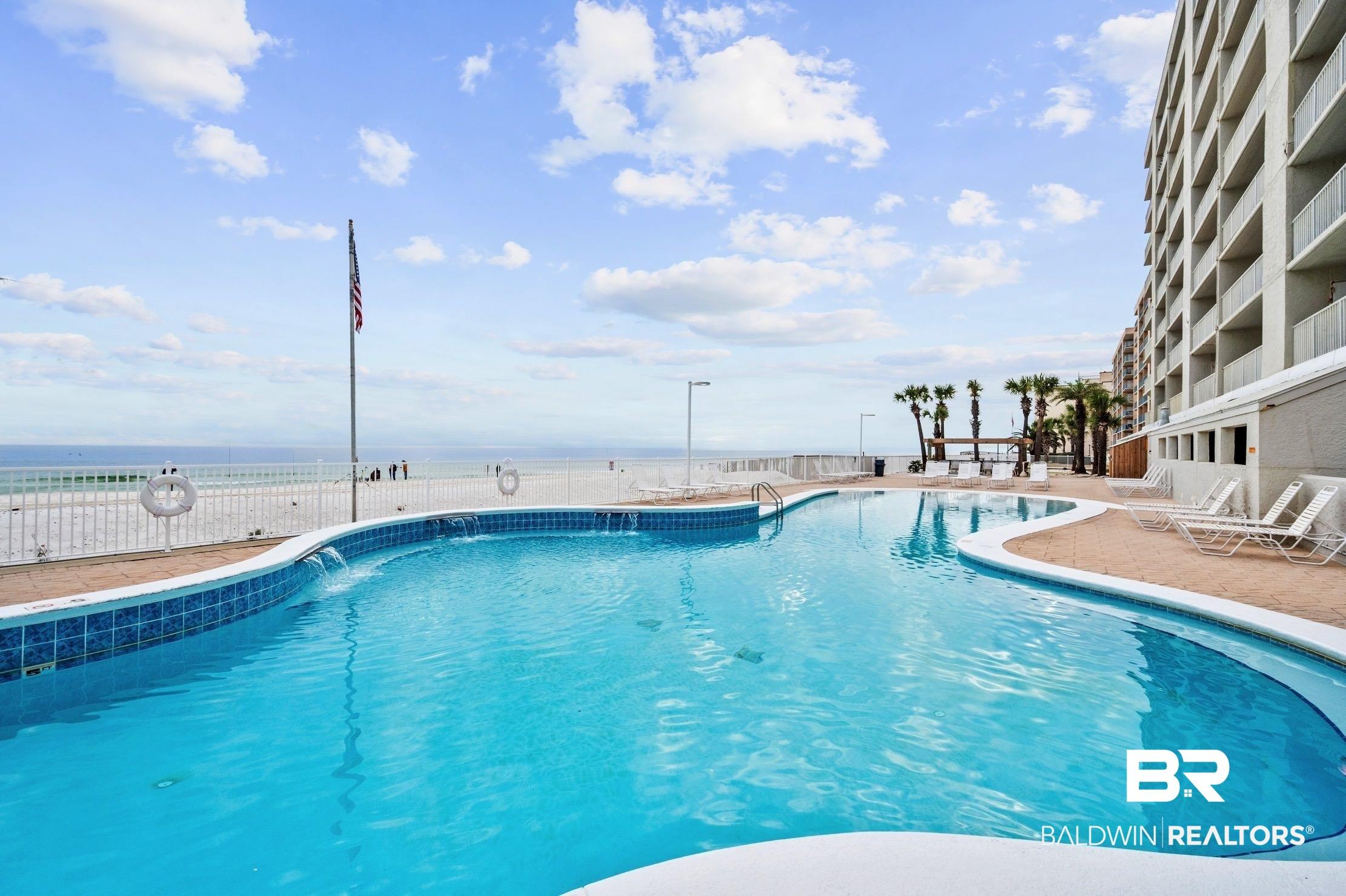 Image 3: Community pool featuring a patio area