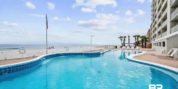 Image 3: Community pool featuring a patio area