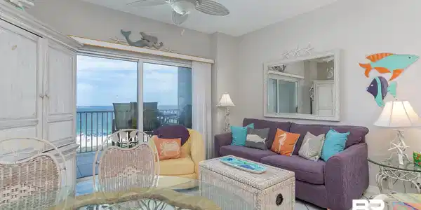 Image 4: Living room with light tile patterned floors, ceiling fan, a textured ceiling, and a water view