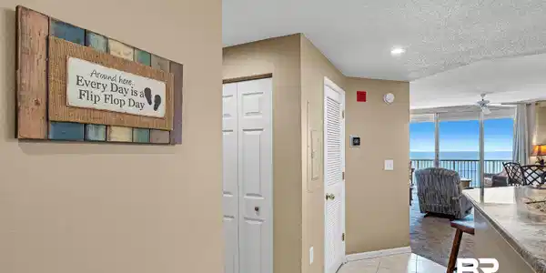 Image 2: Hallway featuring light tile patterned floors, baseboards, a water view, and a textured ceiling
