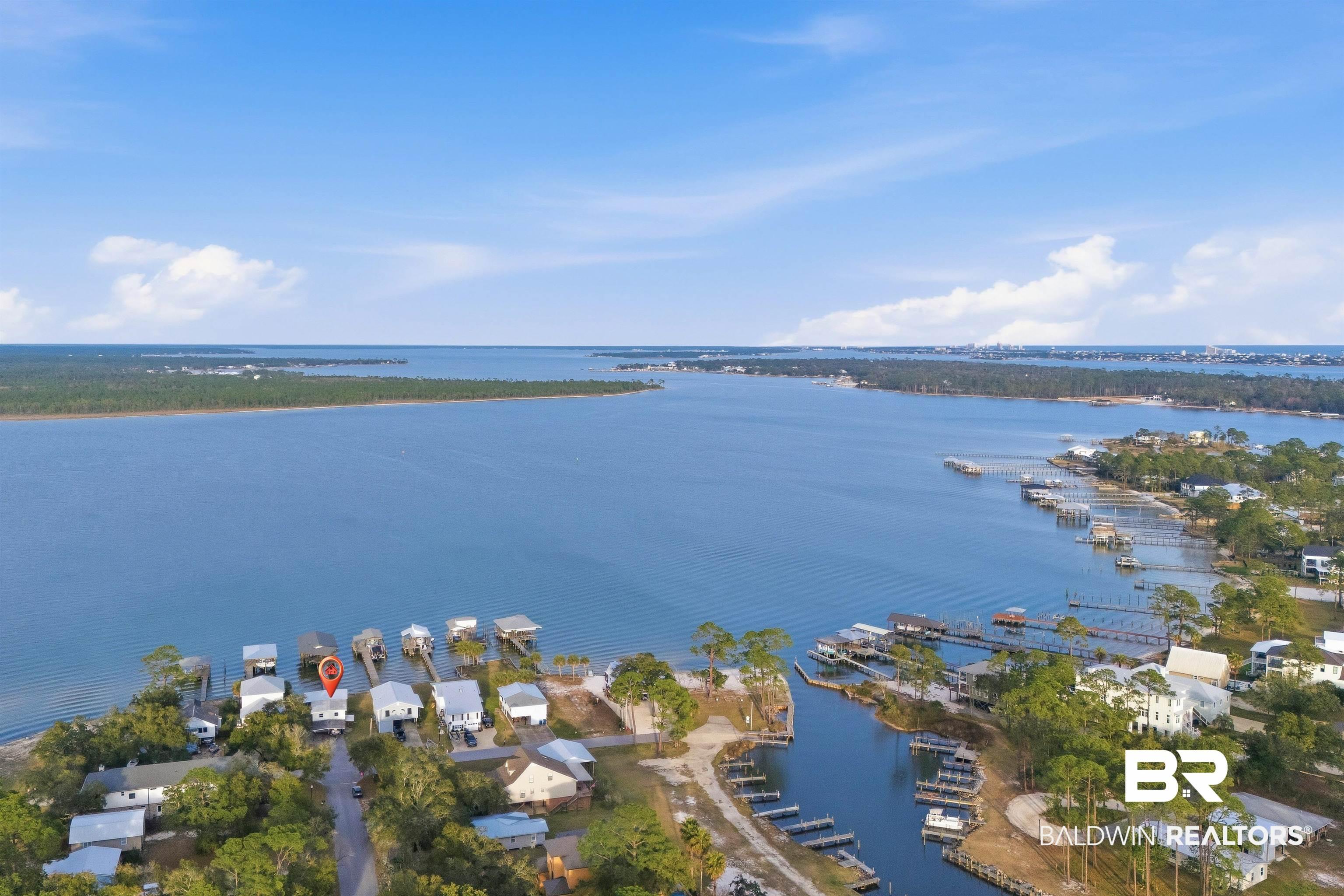 Image 3: Aerial perspective of suburban area with a large body of water