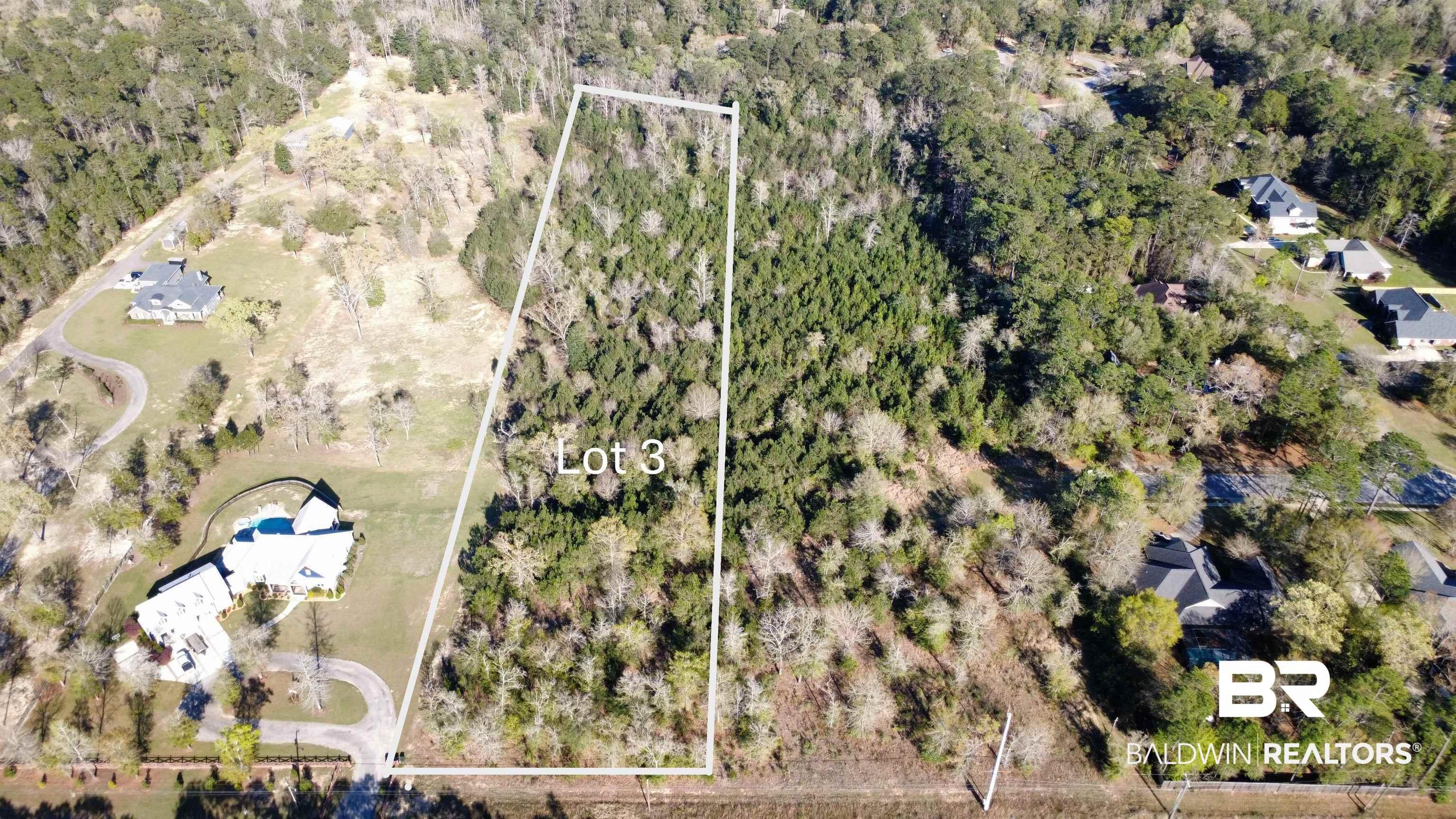 Image 1: Aerial overview of property's location featuring property parcel outlined and a forest