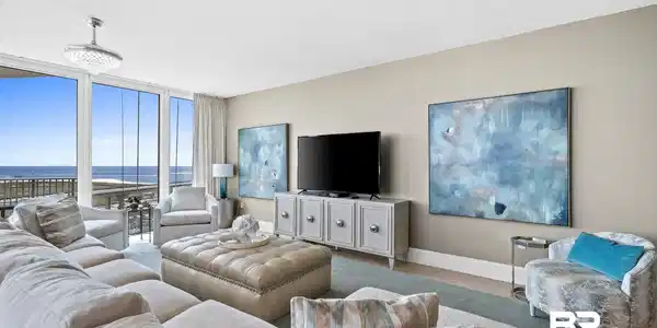 Image 2: Living area with floor to ceiling windows, baseboards, and a textured ceiling