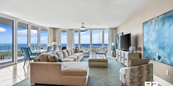 Image 3: Living room featuring tile patterned flooring, expansive windows, baseboards, and a textured ceiling
