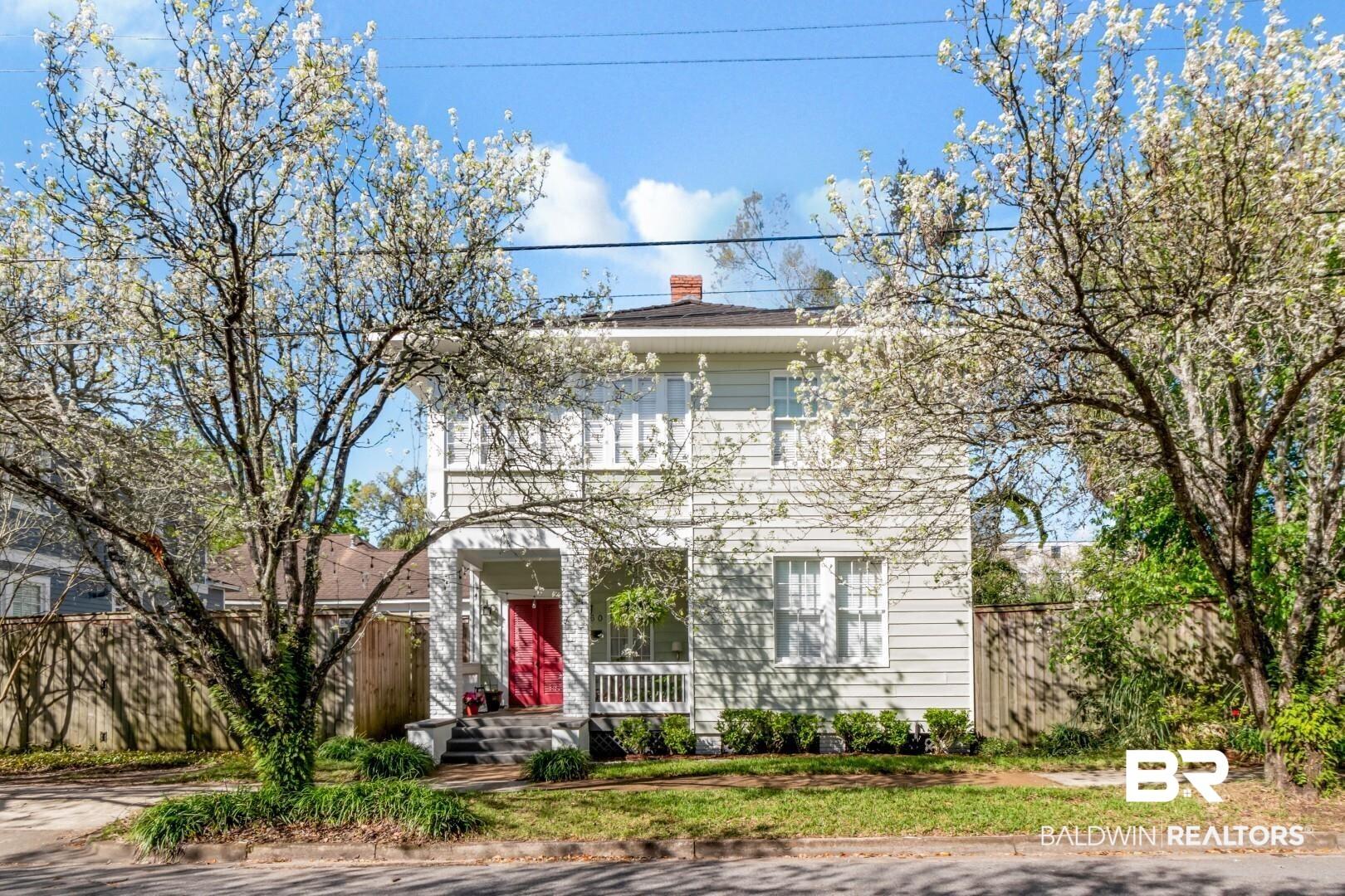 Image 2: View of front of home with a chimney