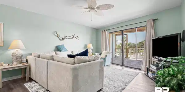Image 2: Living area featuring wood-finish flooring, a ceiling fan, and direct access to an outdoor deck through sliding glass doors