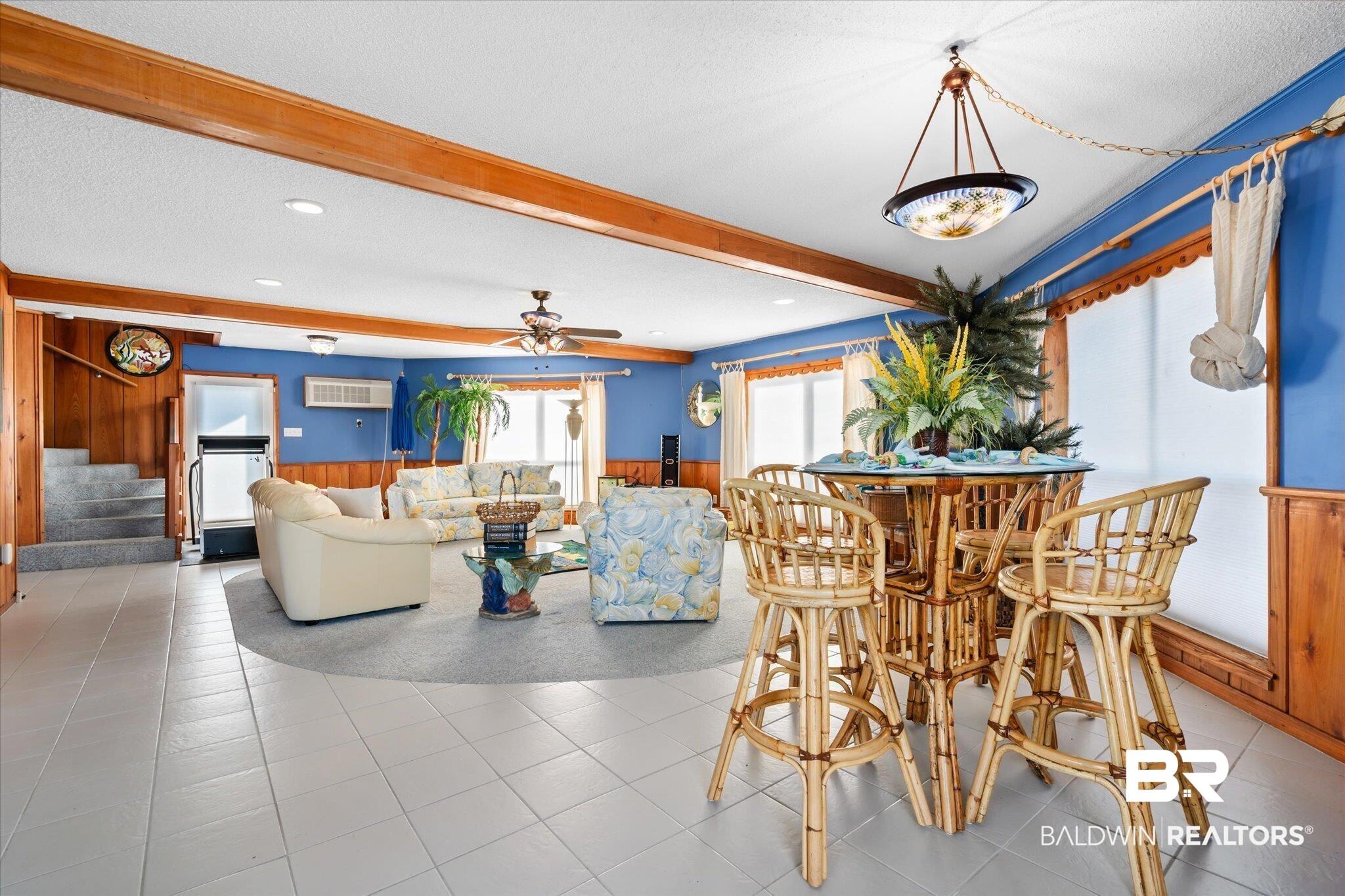 Image 2: Tiled dining area featuring beam ceiling, a textured ceiling, and ceiling fan