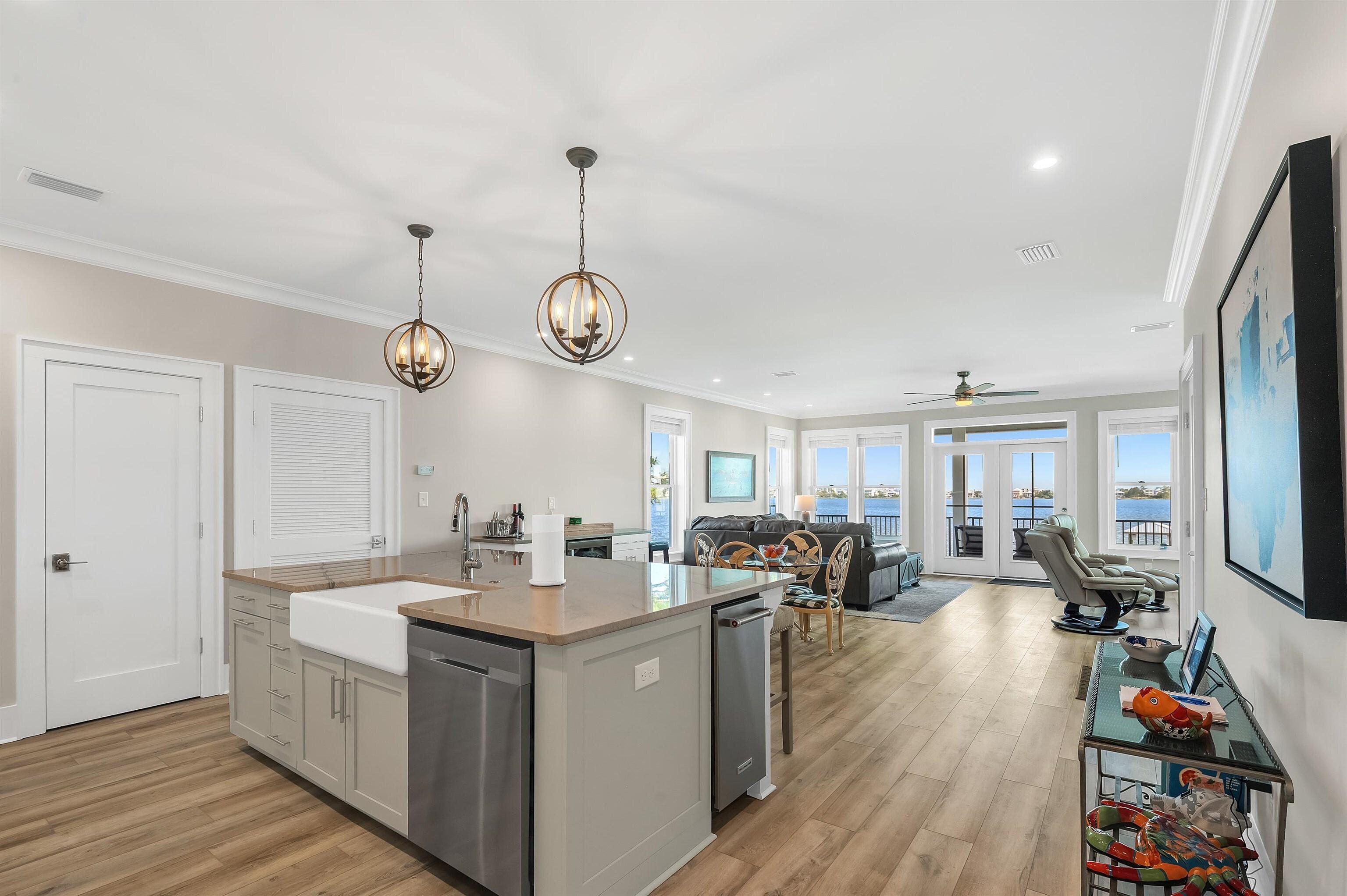 Image 3: Kitchen with visible vents, stainless steel dishwasher, a sink, open floor plan, and light wood-style floors