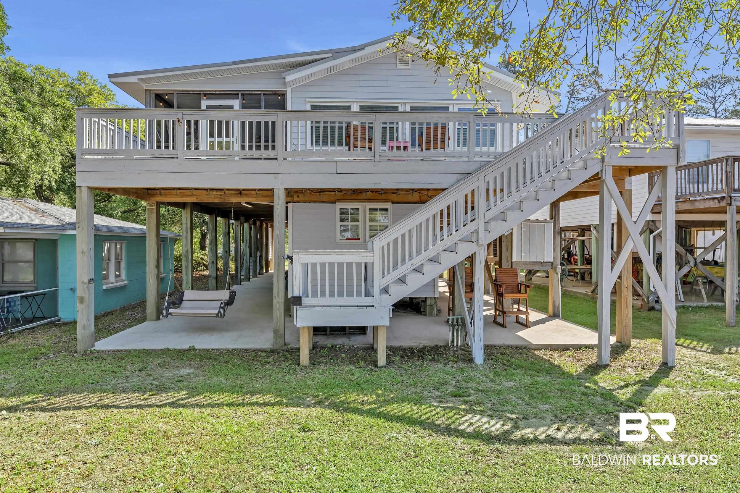 Image 3: Rear view of house featuring a patio, a yard, and a wooden deck