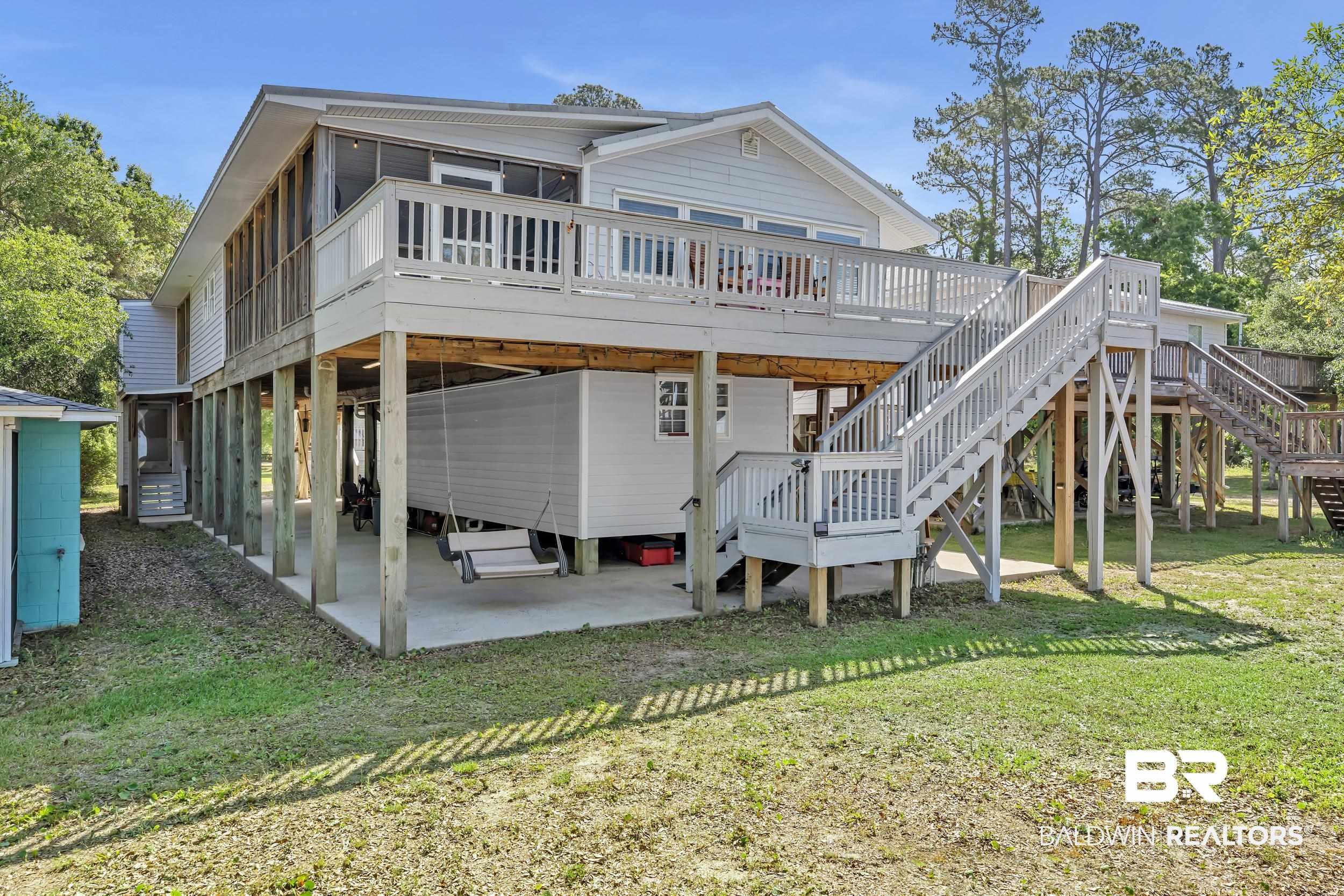 Image 4: Rear view of house featuring a yard, a patio, and a deck