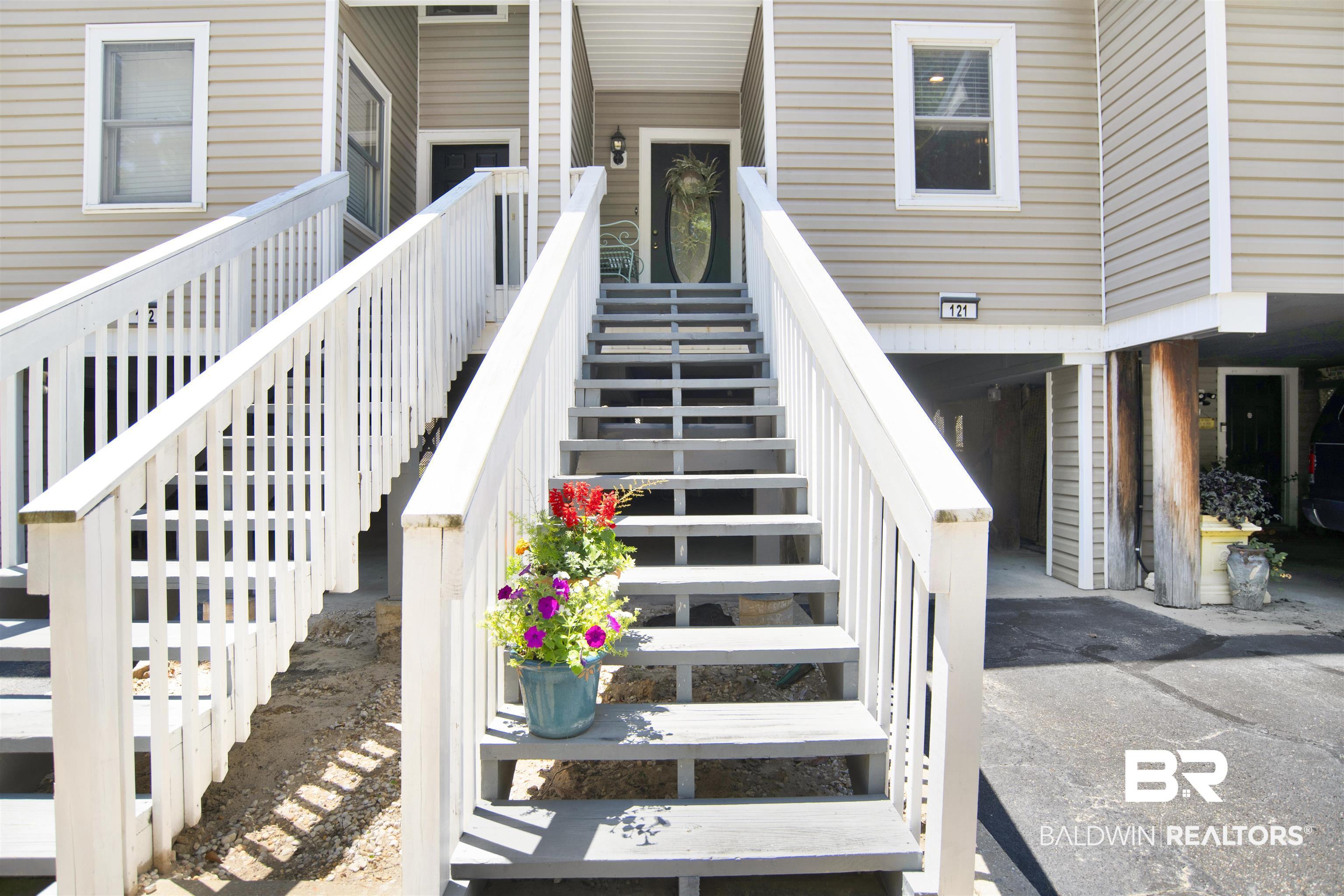 Image 3: Exterior facade featuring horizontal siding and white trim