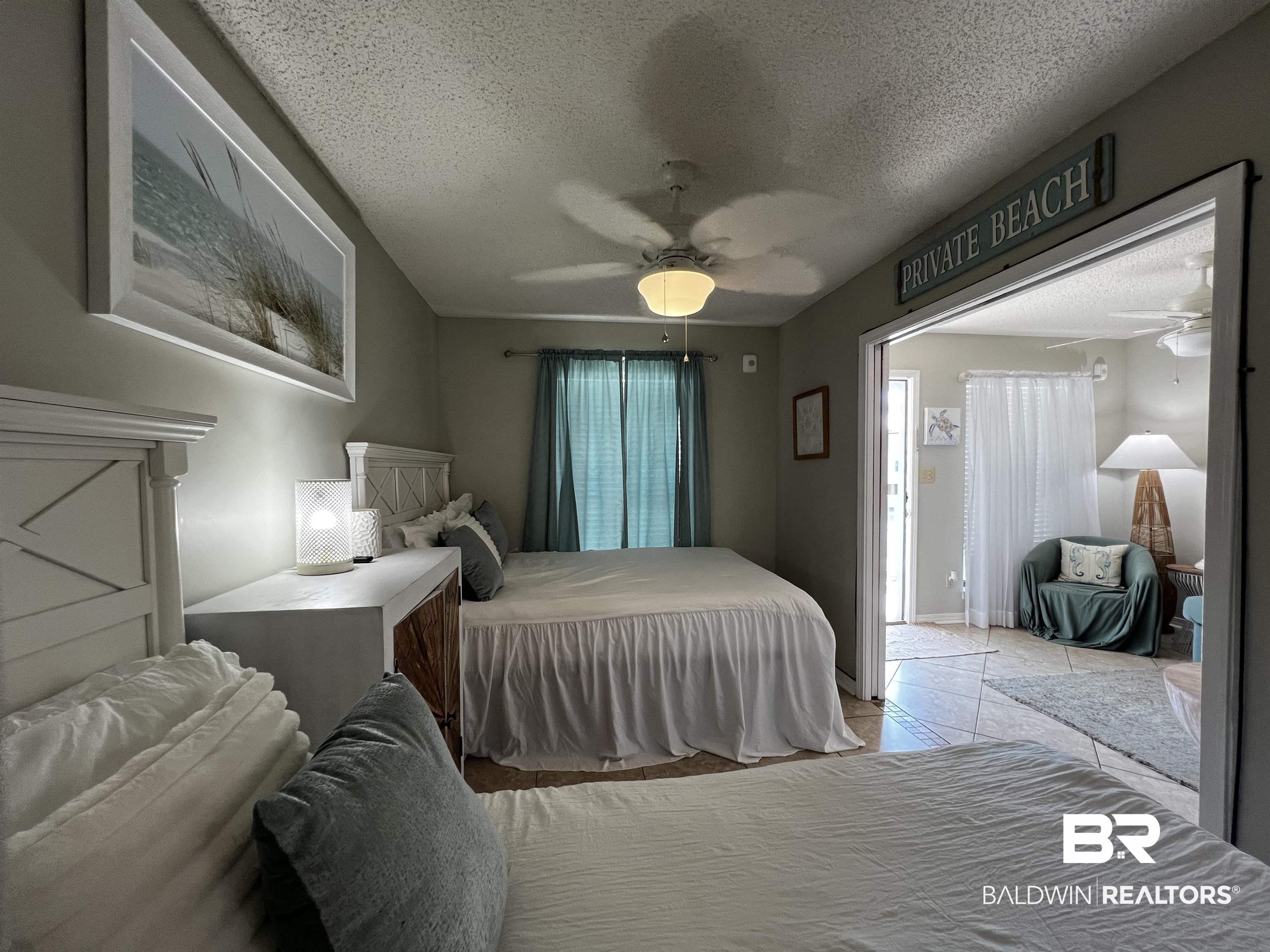 Image 3: Bedroom with a textured ceiling and a ceiling fan
