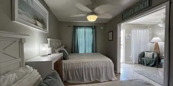 Image 3: Bedroom with a textured ceiling and a ceiling fan