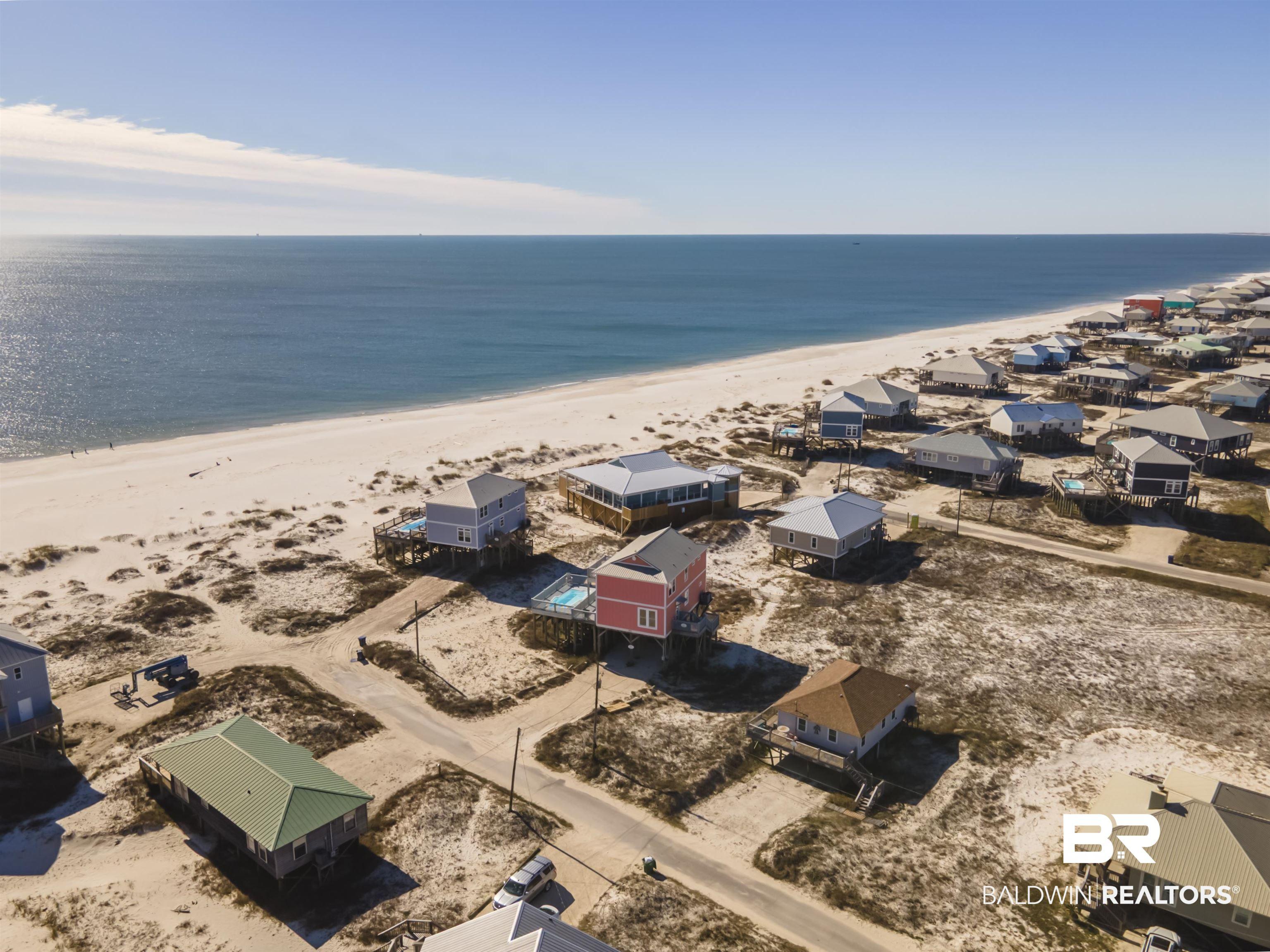 Image 2: Aerial view of residential area with waterfront with a beach
