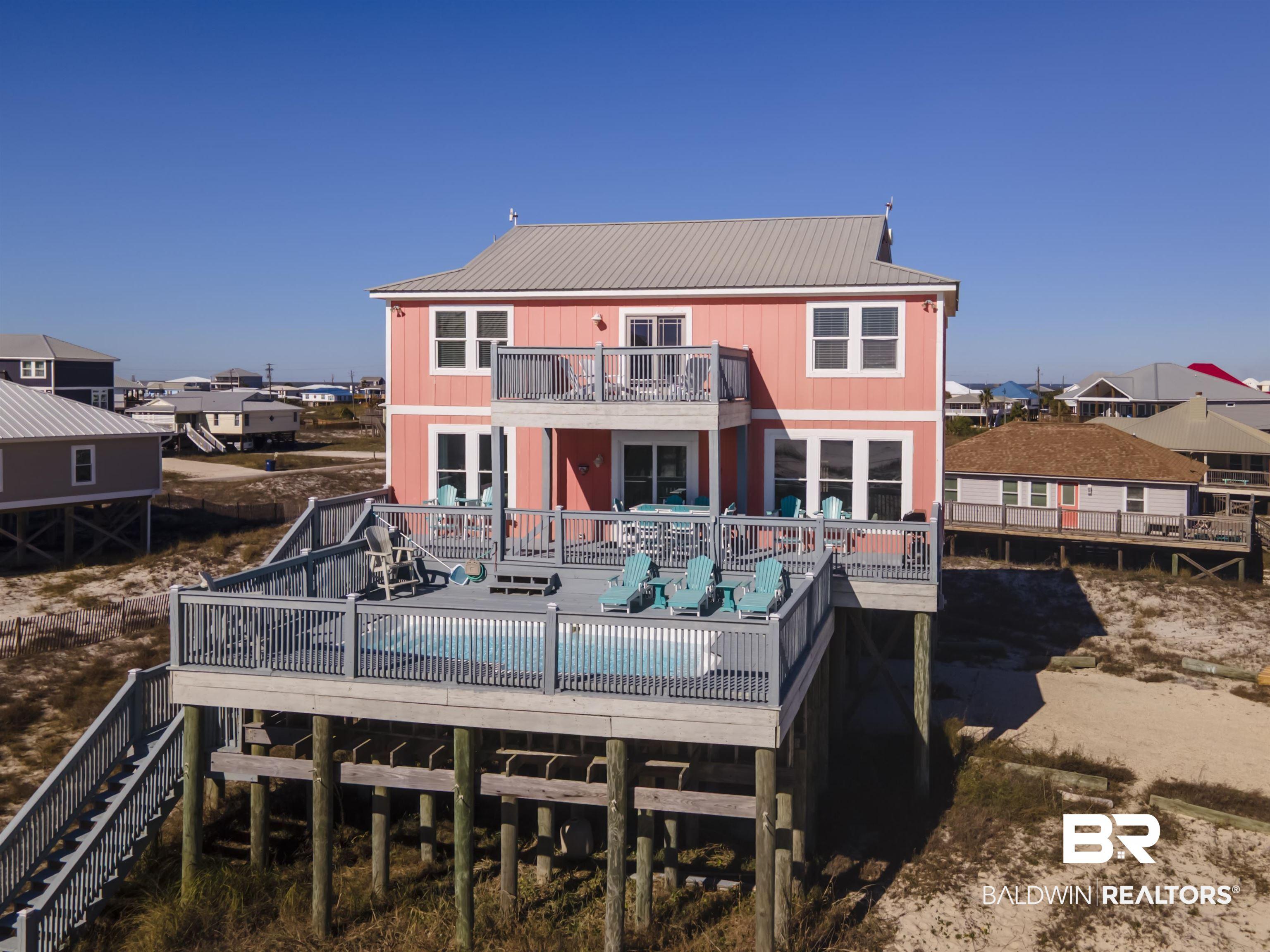 Image 3: Back of property featuring a deck, stairs, and a metal roof