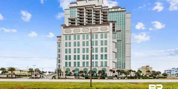 Image 2: Multi-story building featuring a stepped architectural design and extensive window fenestration