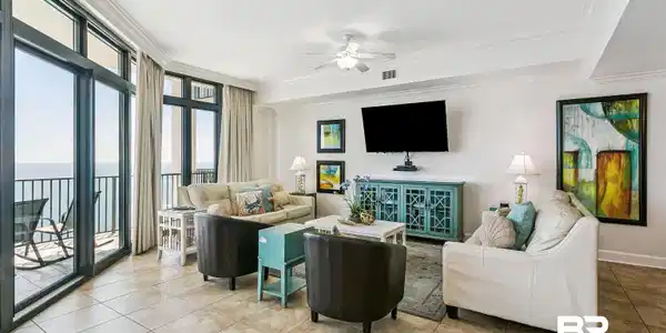 Image 4: Spacious living area featuring large format tile flooring, crown molding, and a ceiling fan