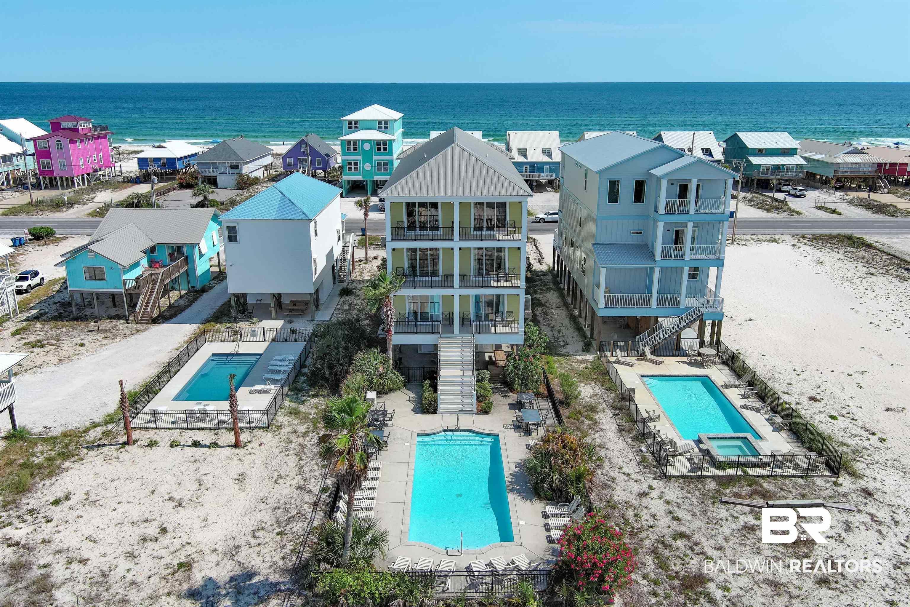 Image 3: Three-story coastal residence featuring multiple balconies and a private pool