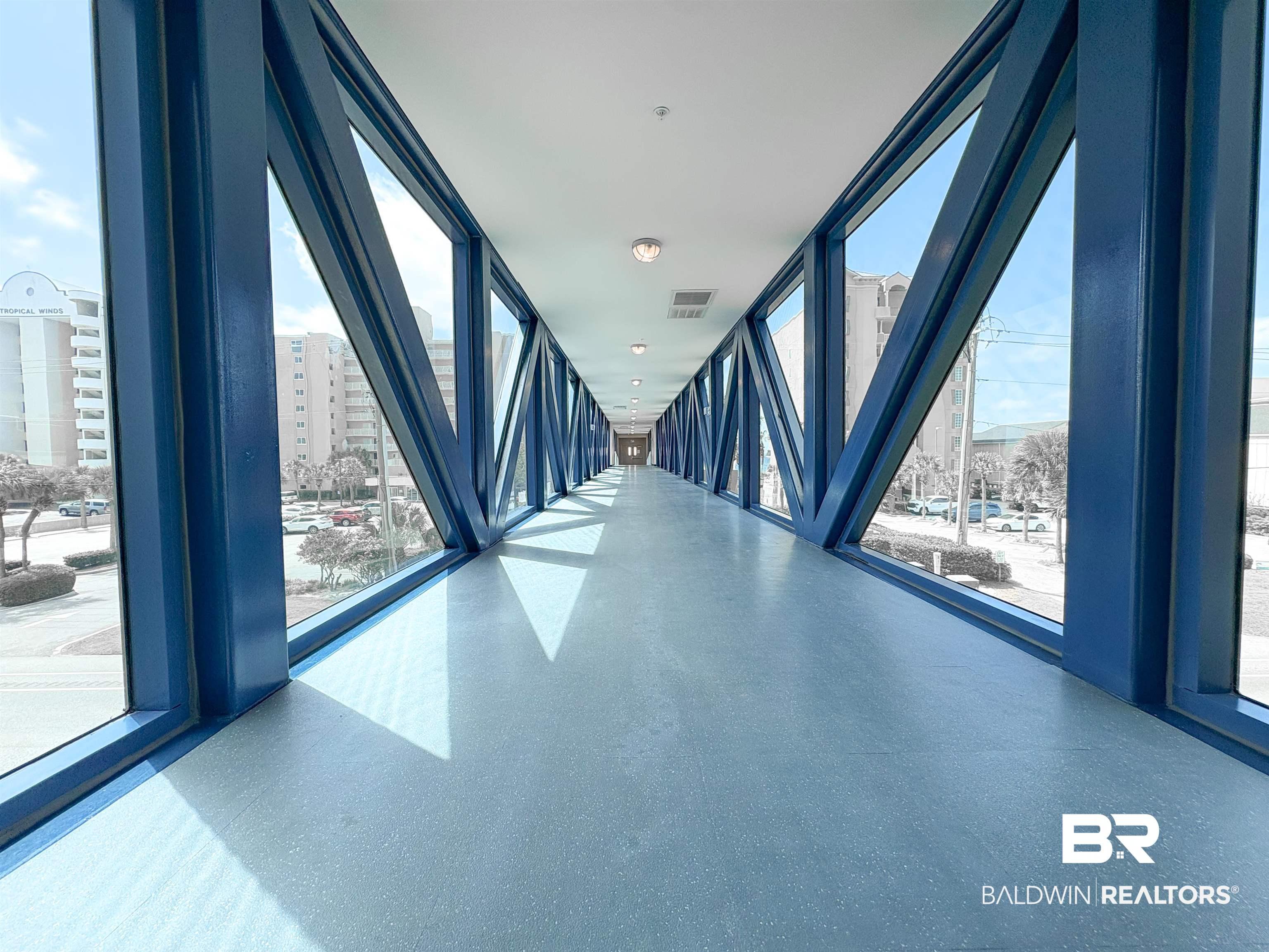 Image 2: Hallway with floor to ceiling windows, a wealth of natural light, and visible vents