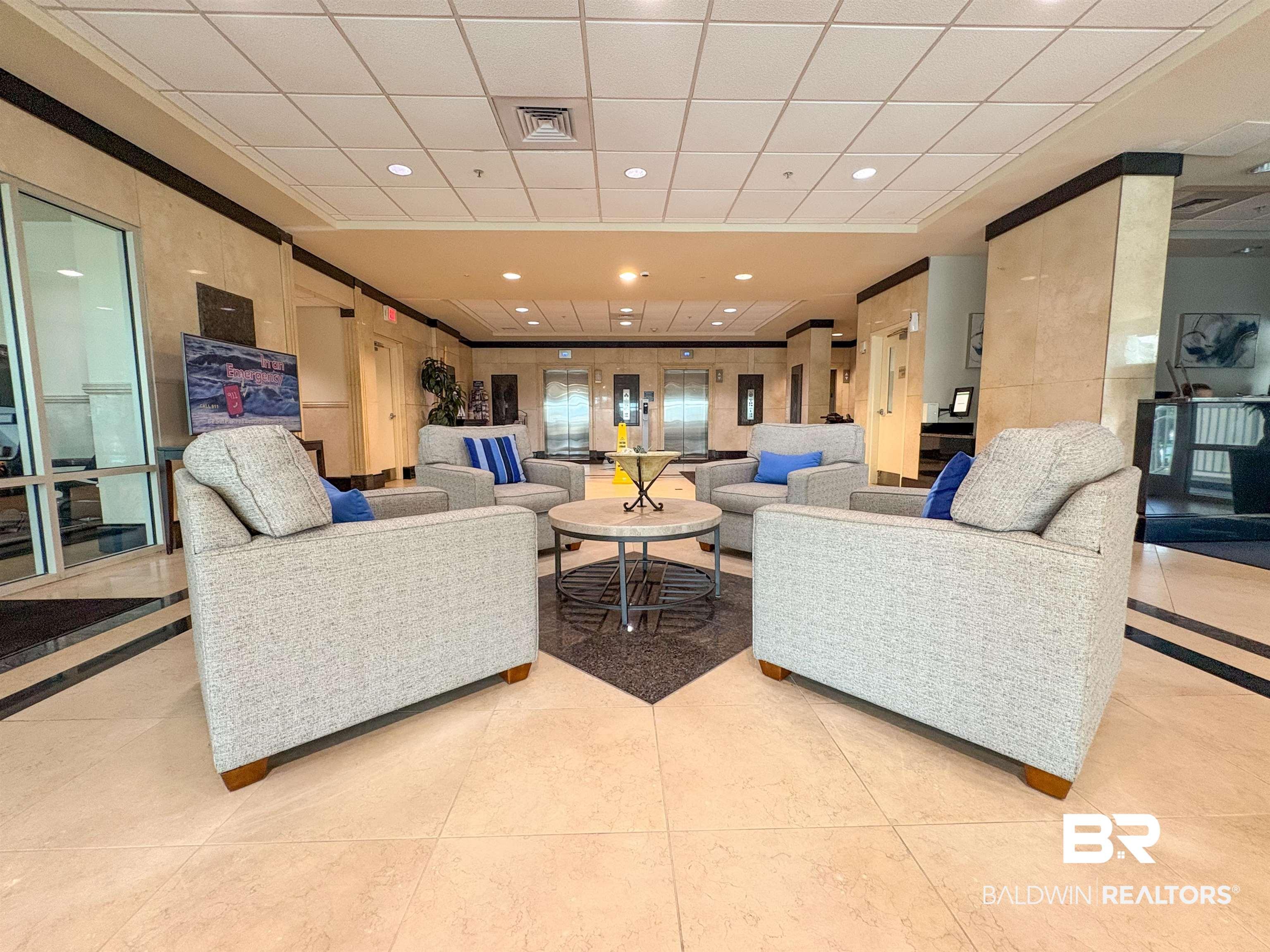 Image 3: Living room with a paneled ceiling, visible vents, ornamental molding, and light tile patterned floors