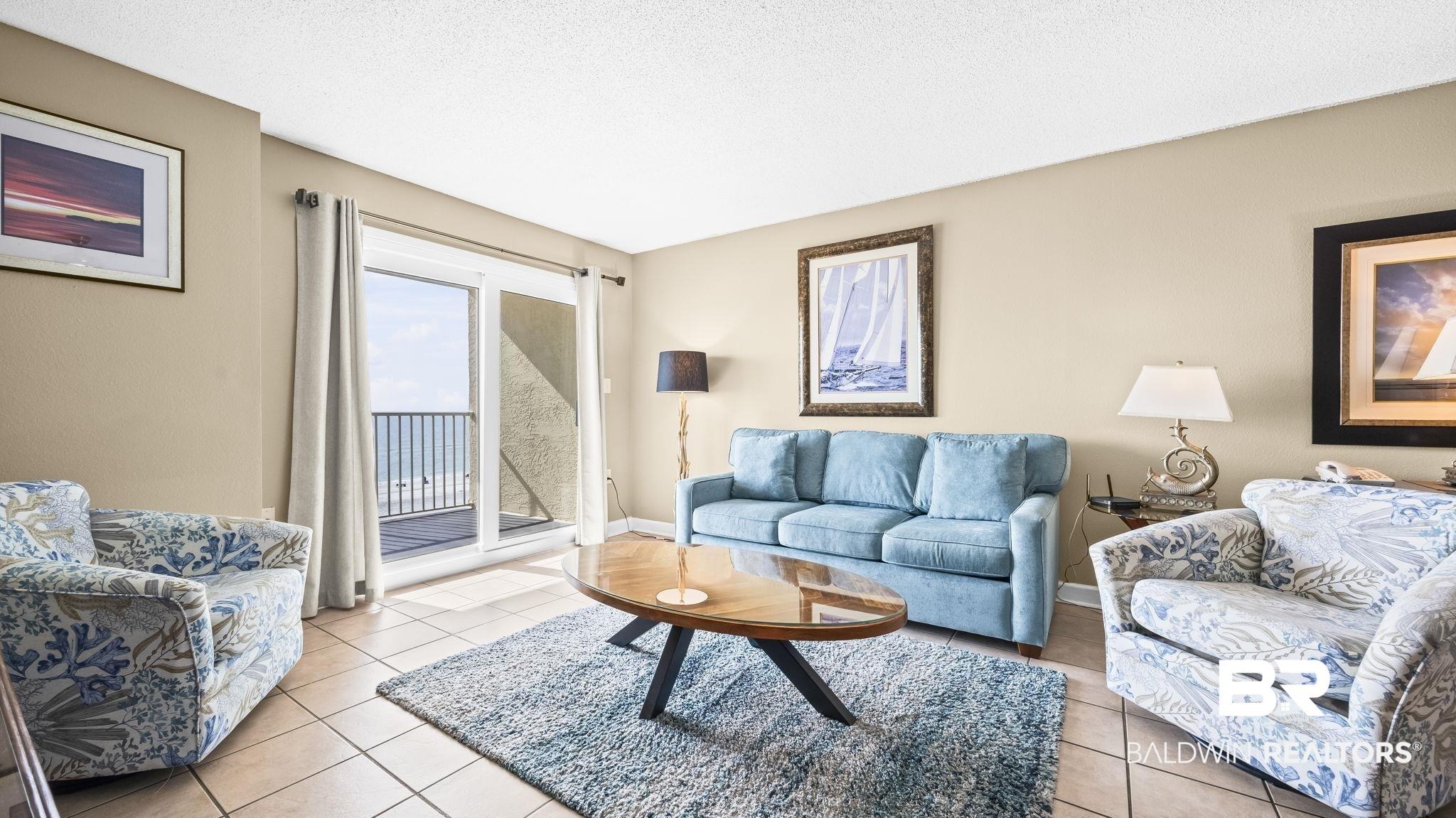 Image 3: Tiled living area with a textured ceiling