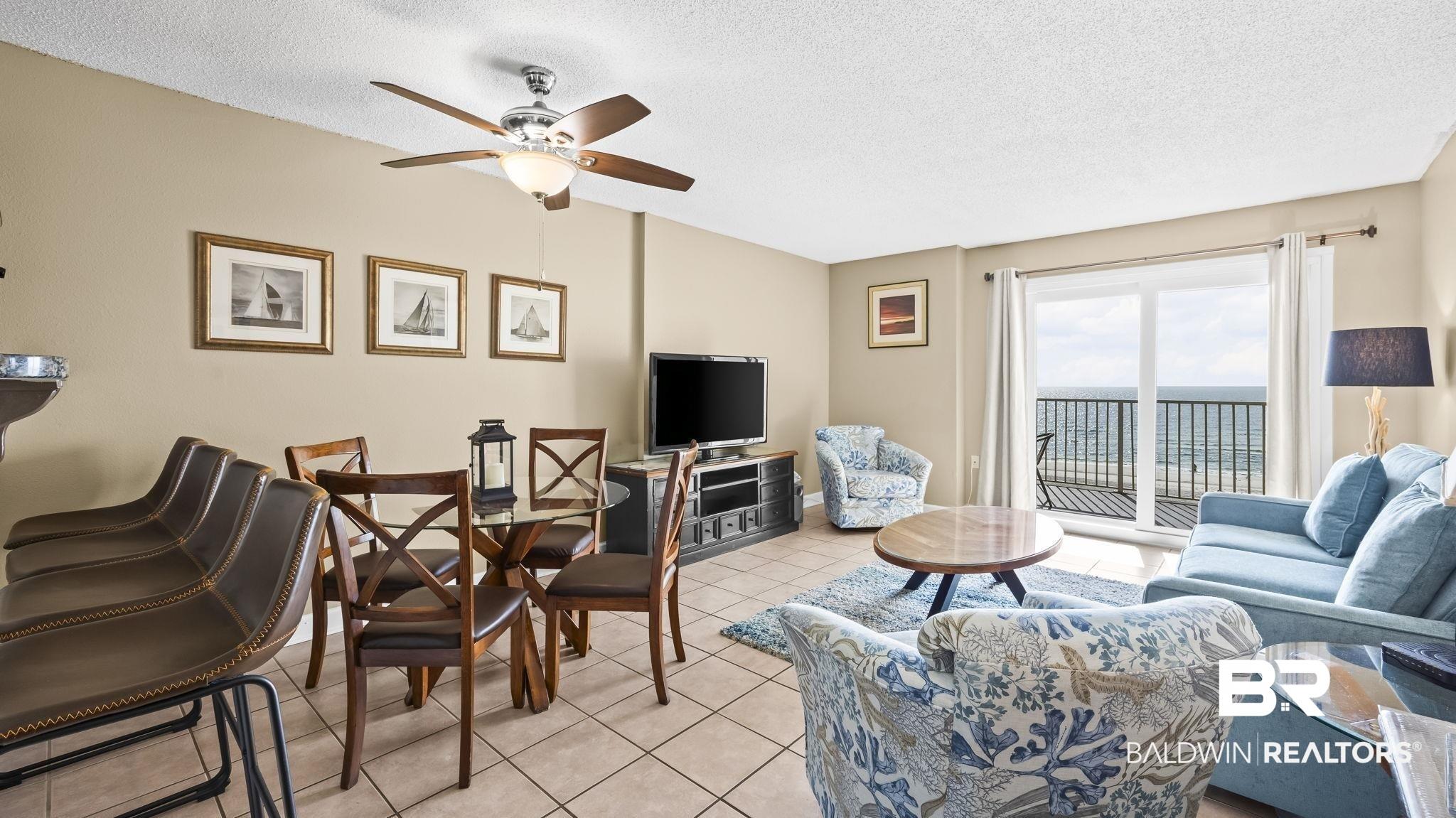 Image 4: Living area featuring a textured ceiling, light tile patterned floors, and ceiling fan