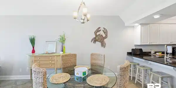 Image 3: Dining room with vaulted ceiling and hanging lights