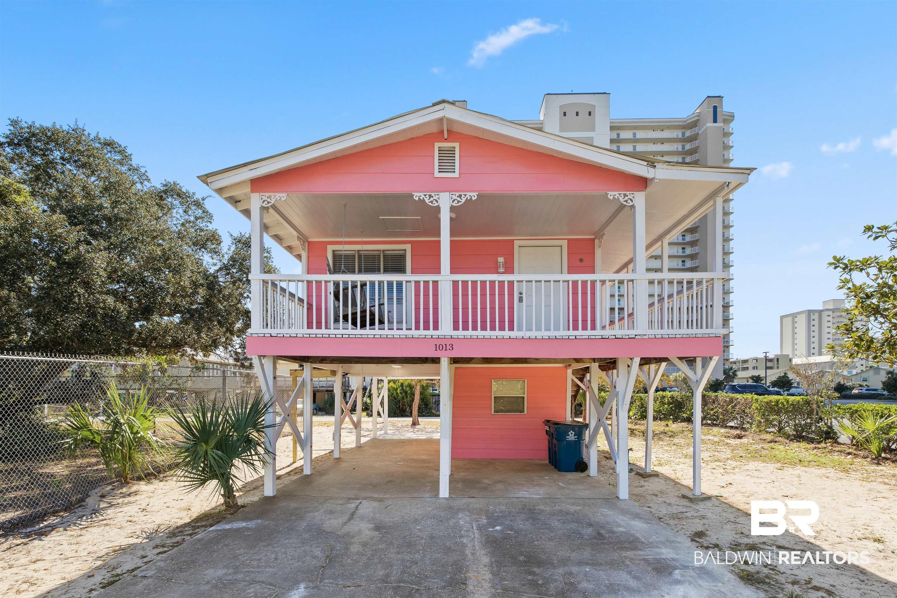Image 1: Beach home with driveway,  and a porch