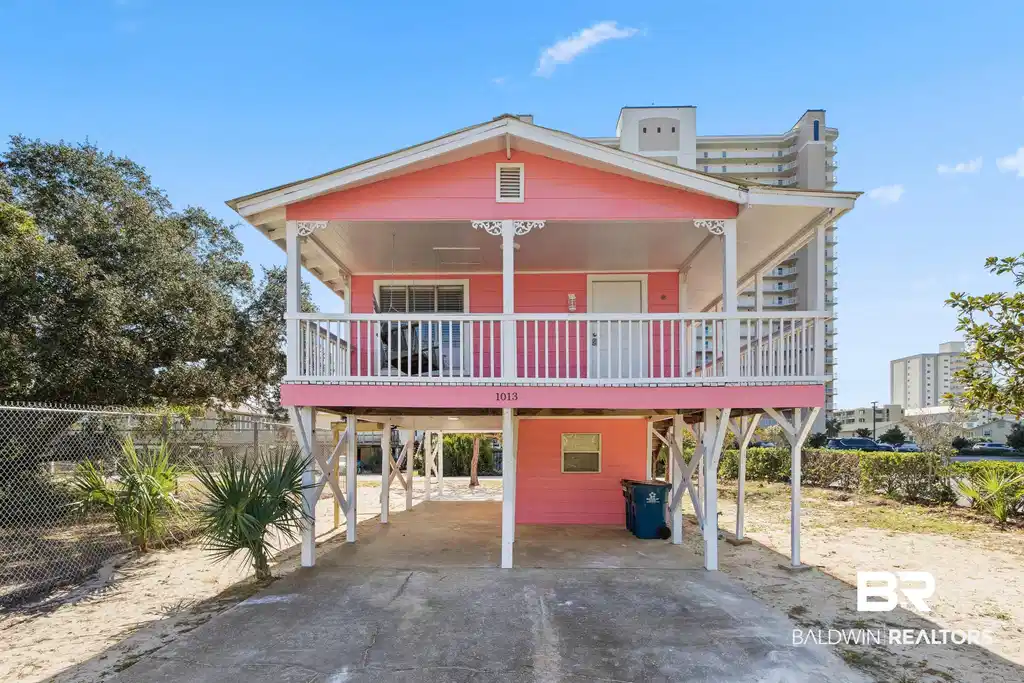 Image 1: Beach home with driveway,  and a porch
