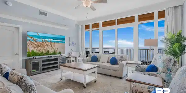 Image 4: Spacious living area featuring floor-to-ceiling windows, crown molding, a ceiling fan, and light-colored flooring