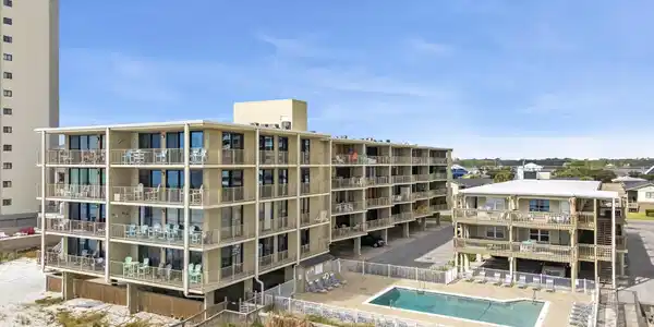 Image 4: View of apartment building / complex with a community pool