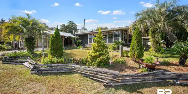 Image 2: View of yard and exterior of home that sits on the corner on 3 lots