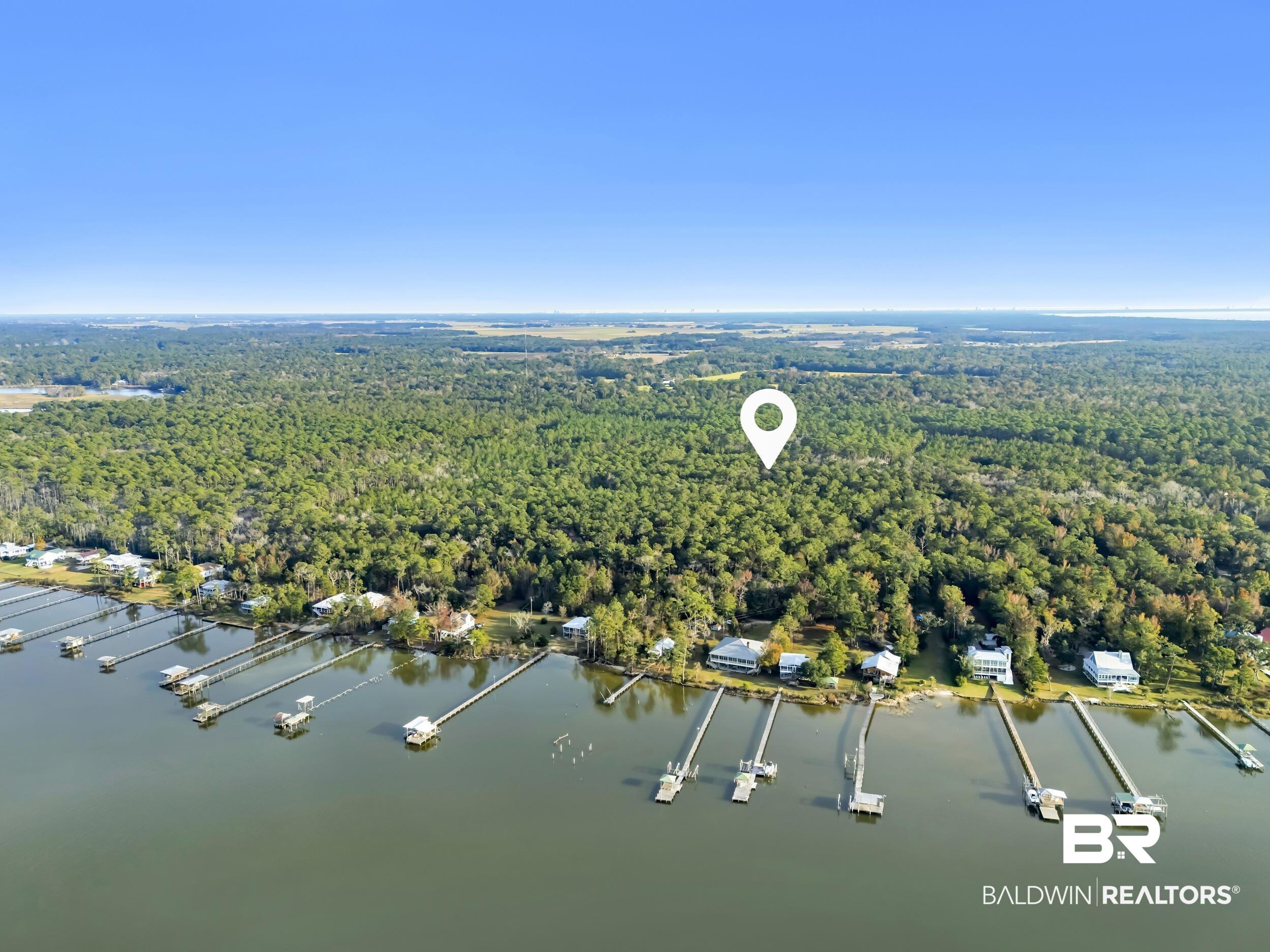 Image 3: View of property location featuring a nearby body of water and a forest