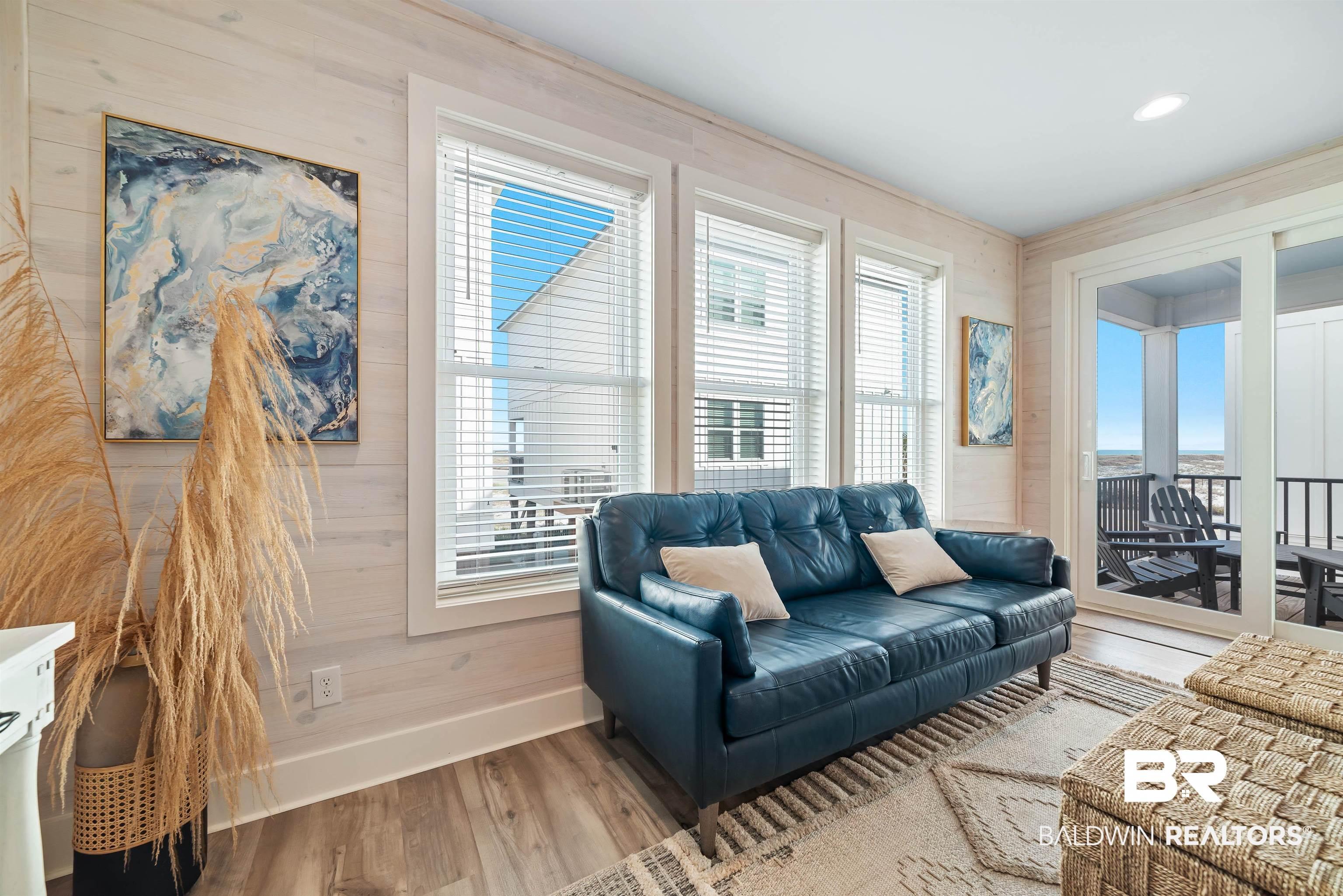 Image 3: Living area featuring wood finished floors and wooden walls