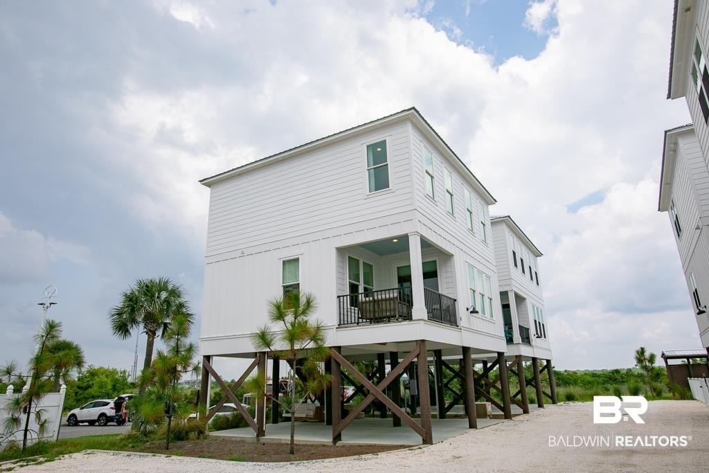 Image 1: View of building exterior with a carport