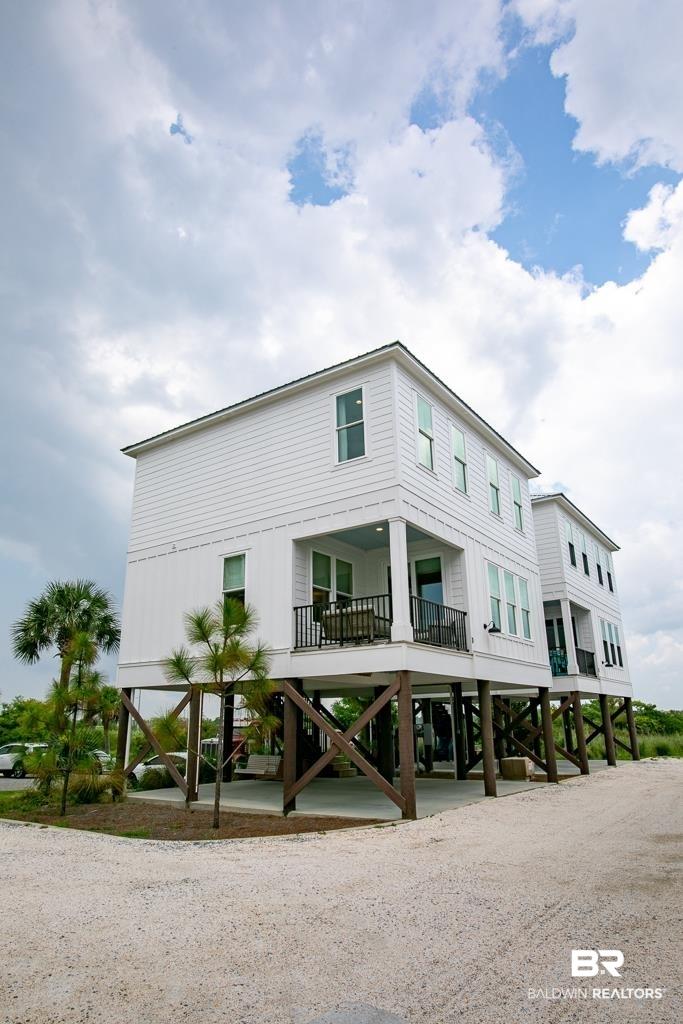Image 2: View of building exterior with a carport