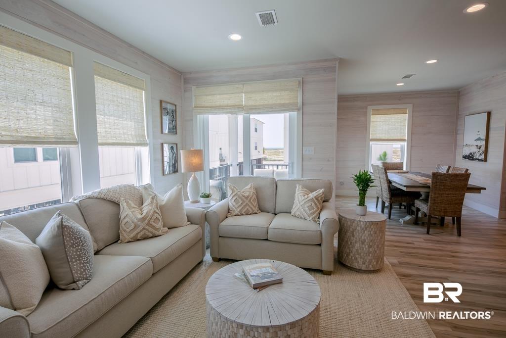 Image 4: Living area featuring wood finished floors and recessed lighting