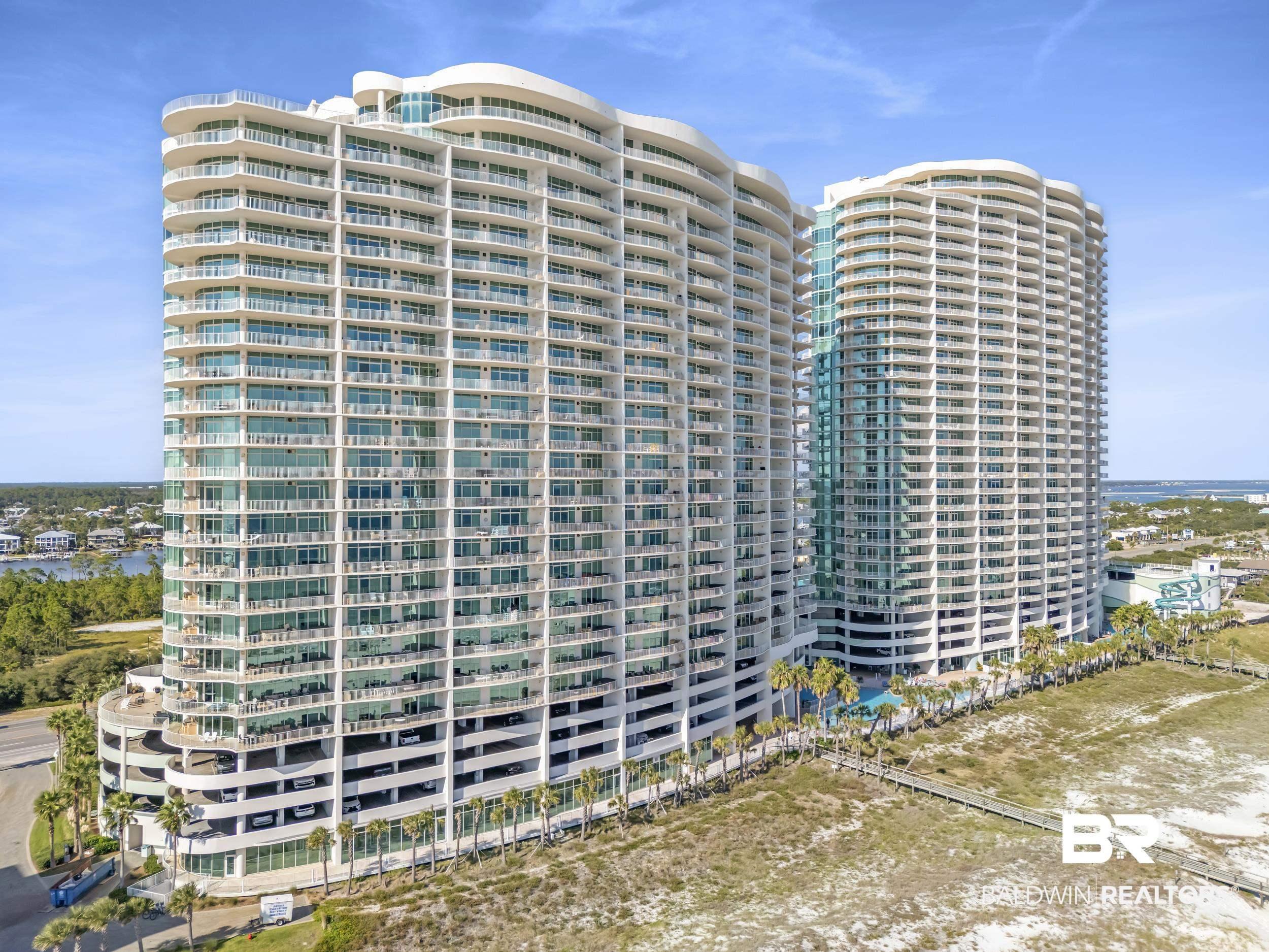 Image 3: Modern high-rise residential buildings featuring numerous private balconies and a curved architectural design