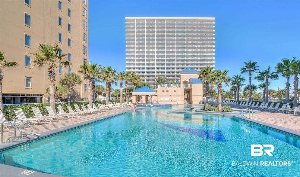 Image 2: Community pool featuring a patio area and a gazebo