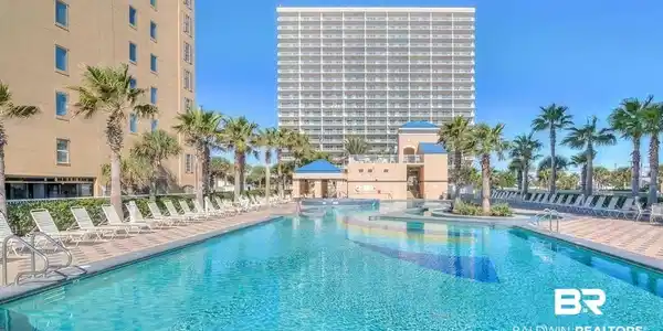 Image 2: Community pool featuring a patio area and a gazebo