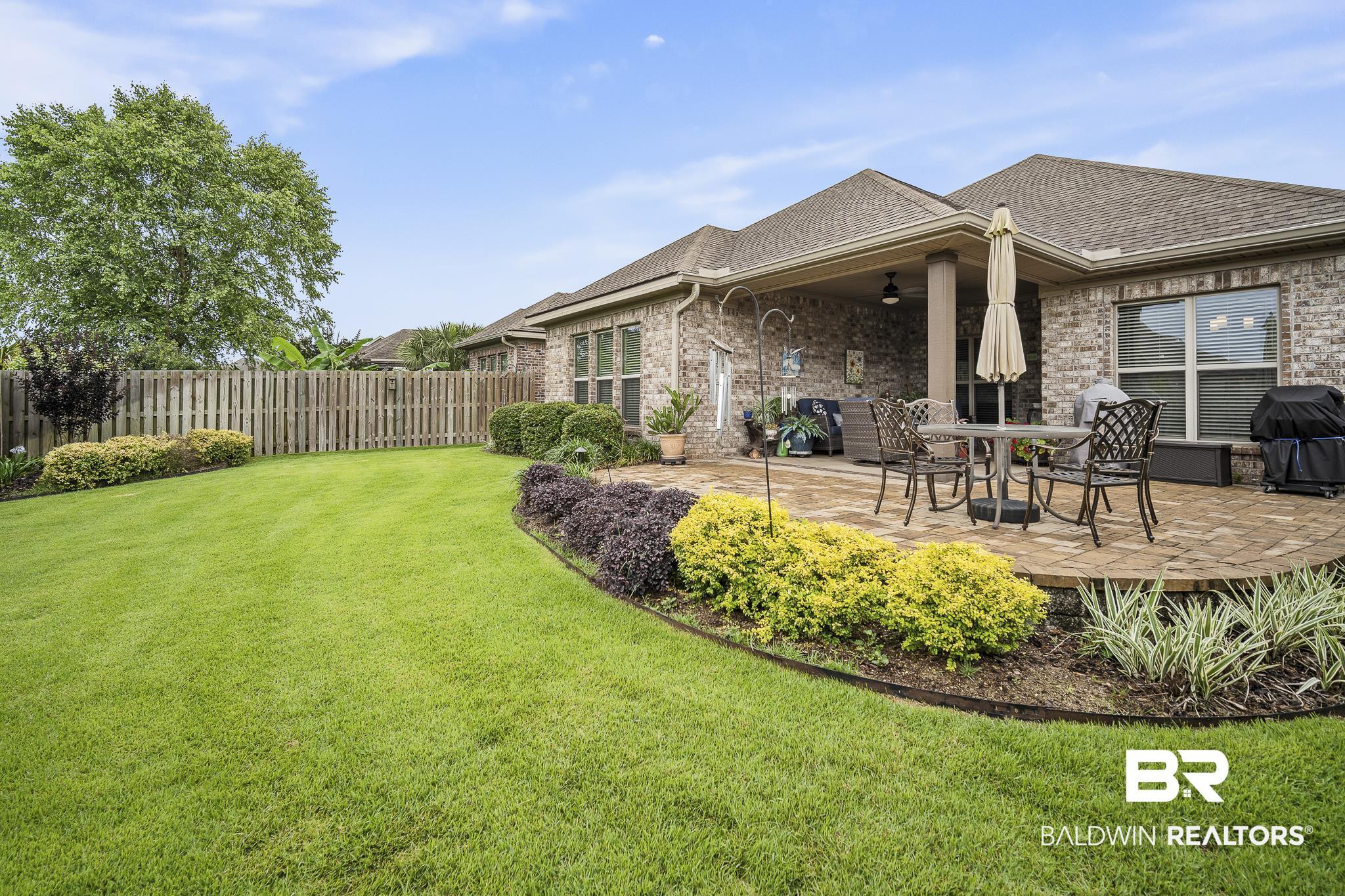 Image 3: Lovely landscaped yard with concrete pavers and zoysia sod!