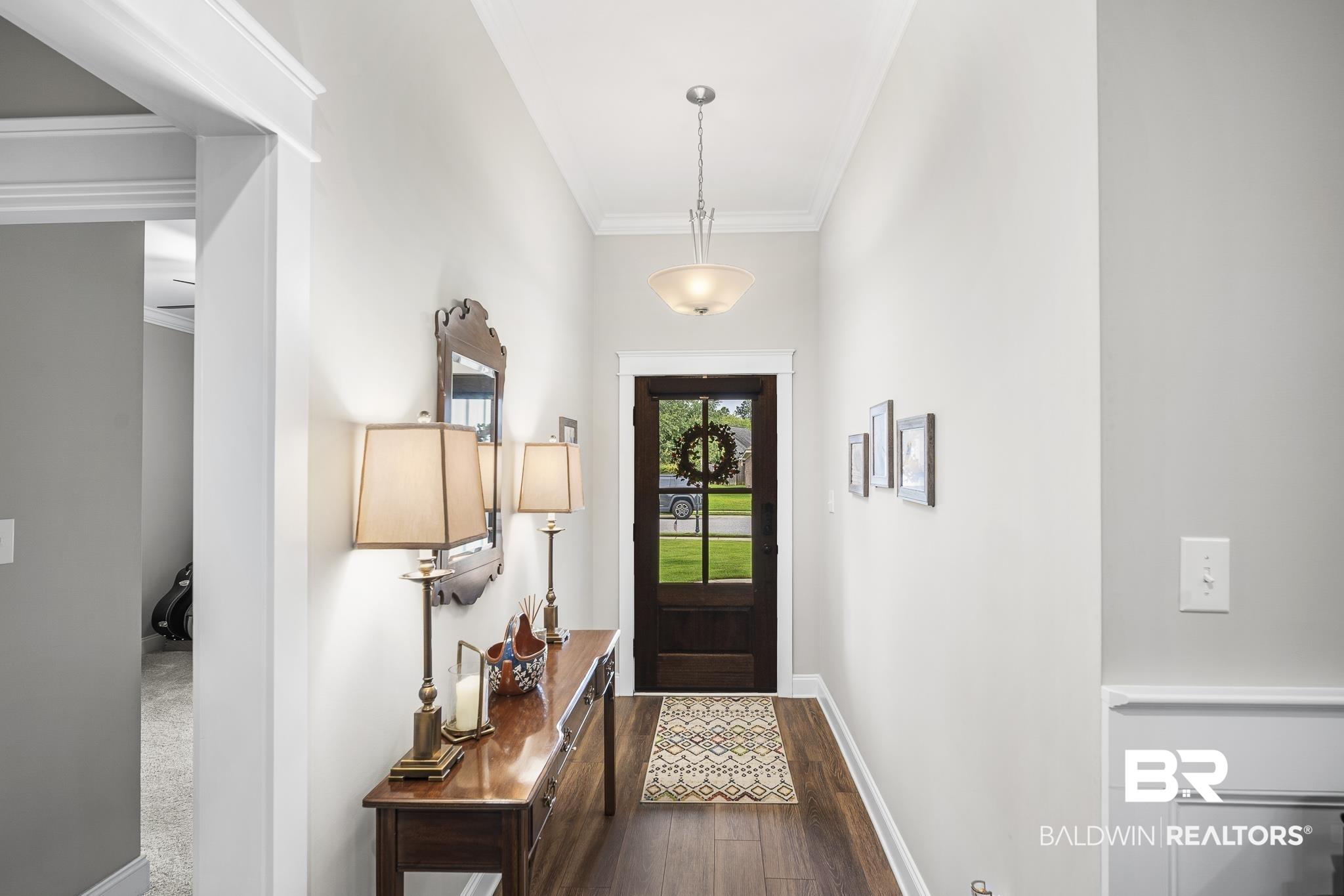 Image 4: Entryway with wood door and natural lighting
