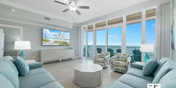 Image 2: Living area featuring ceiling fan, light tile patterned flooring, ornamental molding, and plenty of natural light