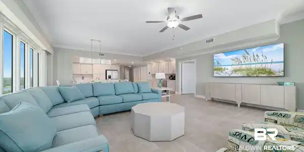 Image 3: Living room featuring crown molding, ceiling fan, and light tile patterned floors