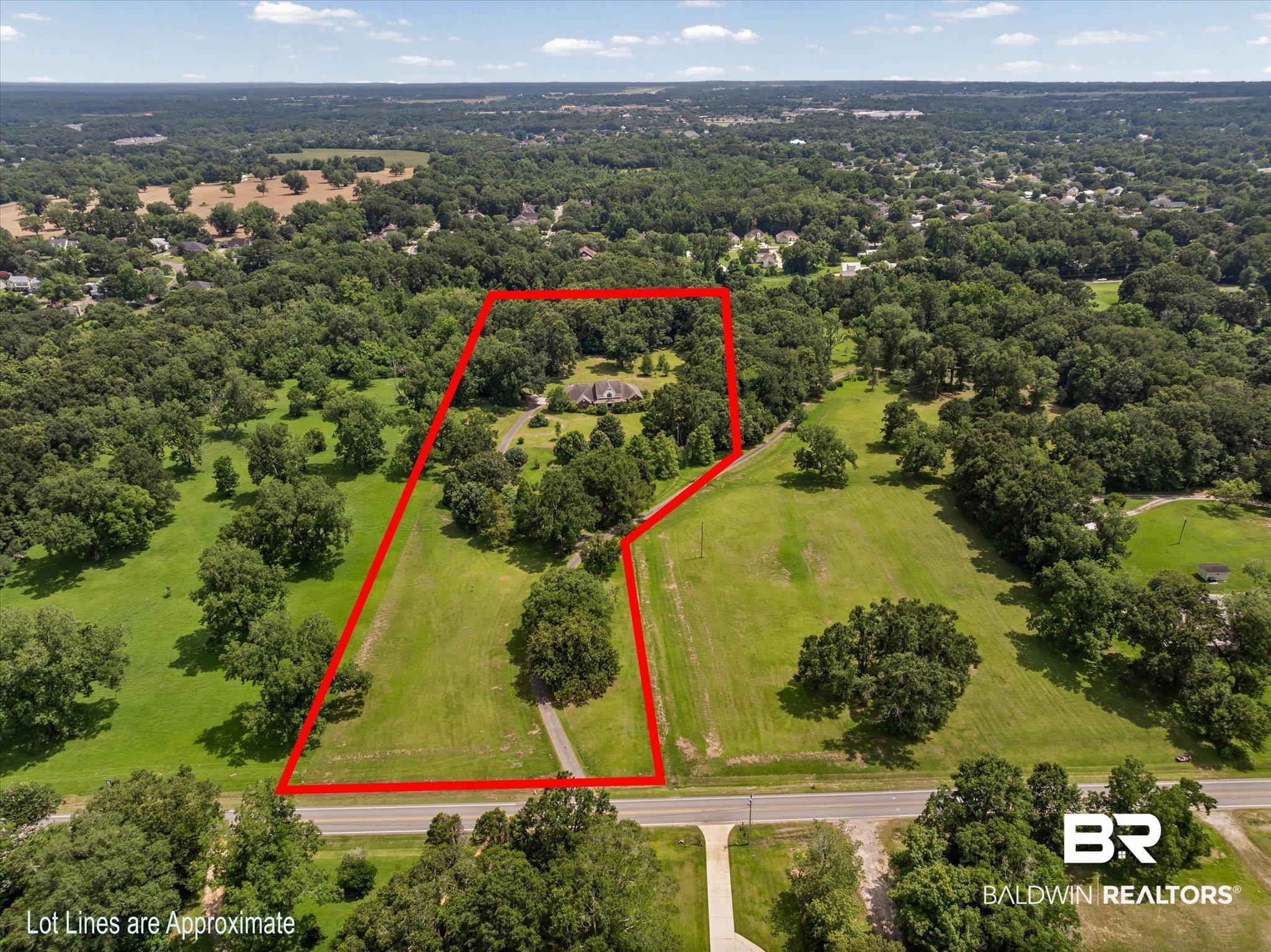 Image 4: Expansive property featuring a residence nestled among mature trees