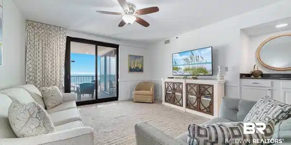 Image 2: Living room with ceiling fan and a wainscoted wall