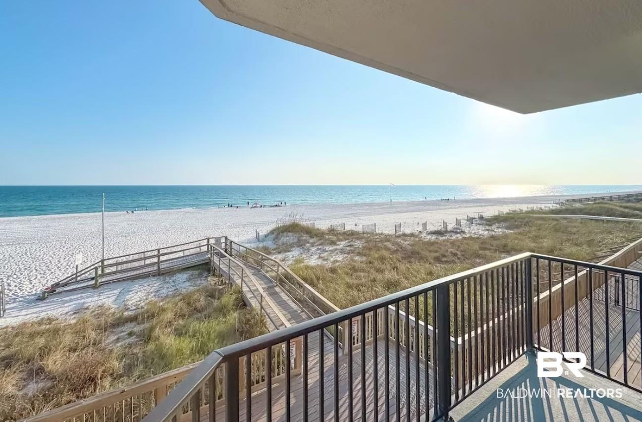 Image 4: Balcony featuring view of water and beach