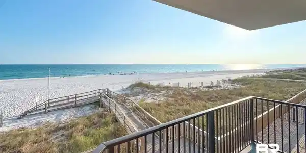 Image 4: Balcony featuring view of water and beach