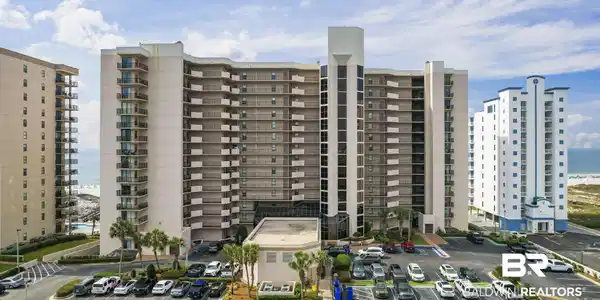 Image 2: View of apartment building / complex featuring a water view and uncovered parking